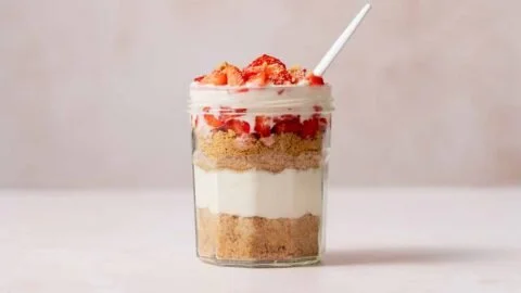 High Protein Cheesecake Jars Recipe 7 High Protein Cheesecake Jars with fresh berries and a creamy topping
