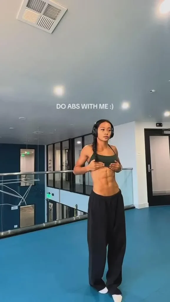 Olivia Jewel demonstrating an abs workout with 2-3 sets and plank exercise.